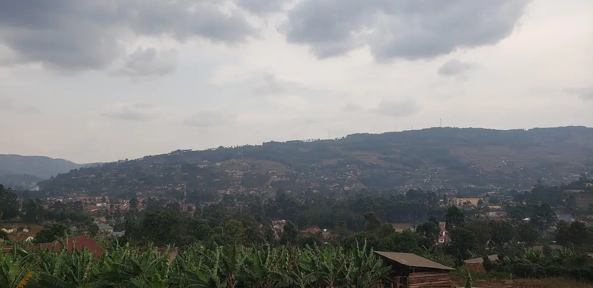 Hazy farm landscape of rolling hills in Kabale District