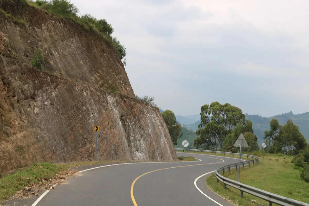 Winding paved road along a steep cut slope in southwest Uganda